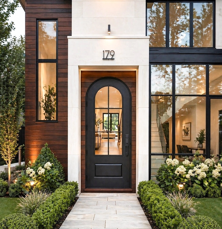 Modern house exterior with a black door and decorative garden